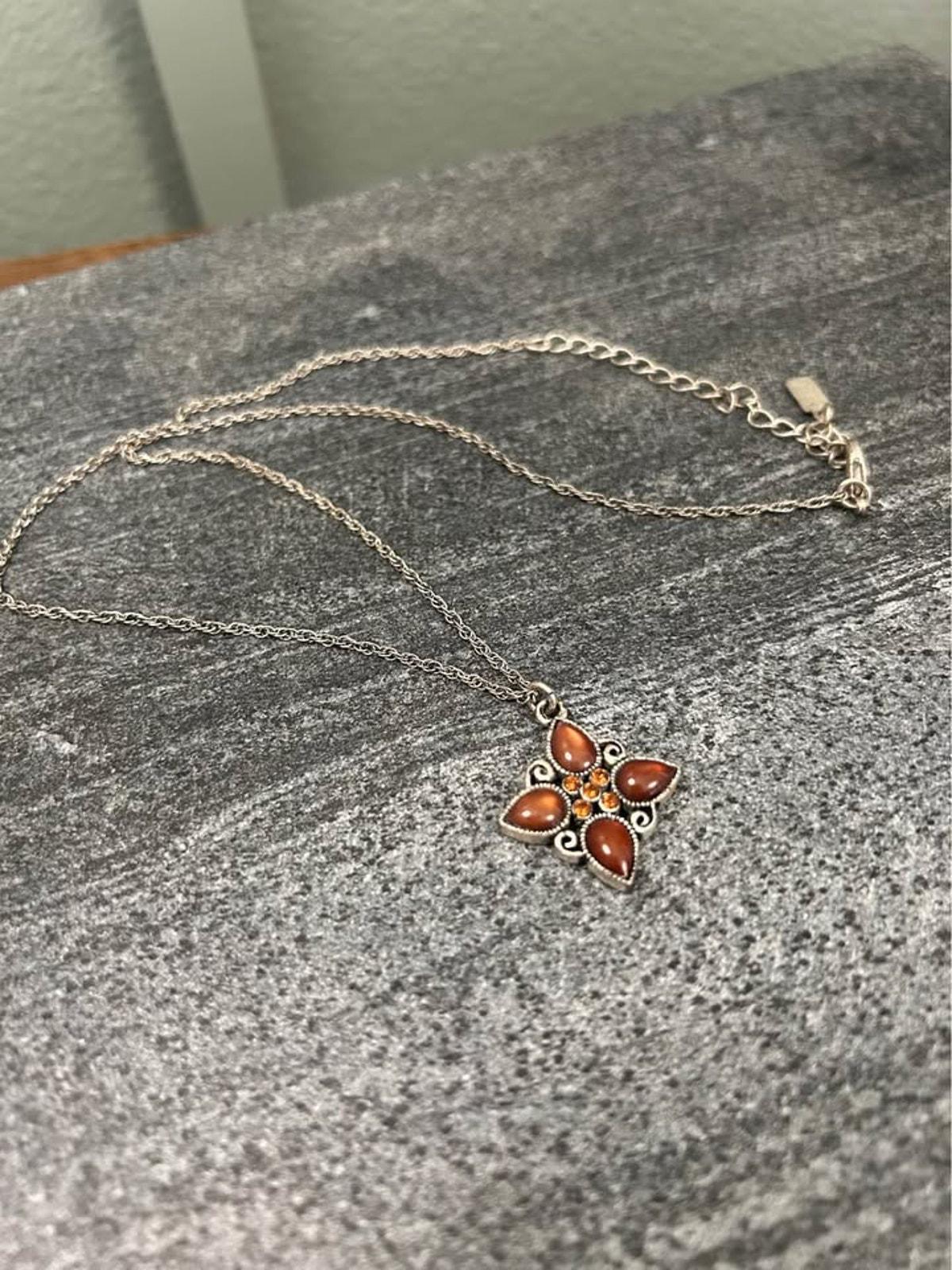 1928 Jewelry Company Silver Tone Quatrefoil Pendant Necklace with Amber Glass