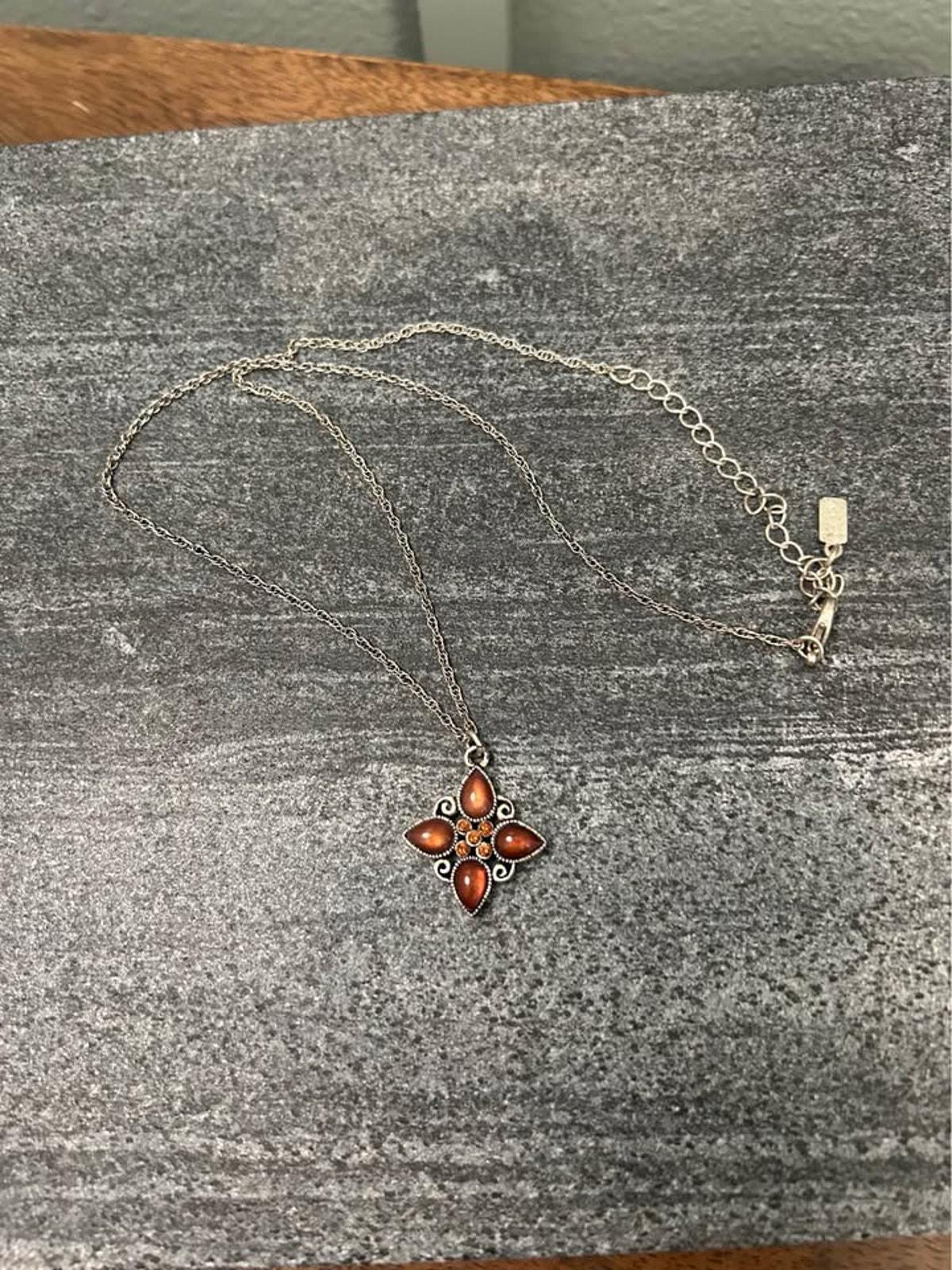 1928 Jewelry Company Silver Tone Quatrefoil Pendant Necklace with Amber Glass